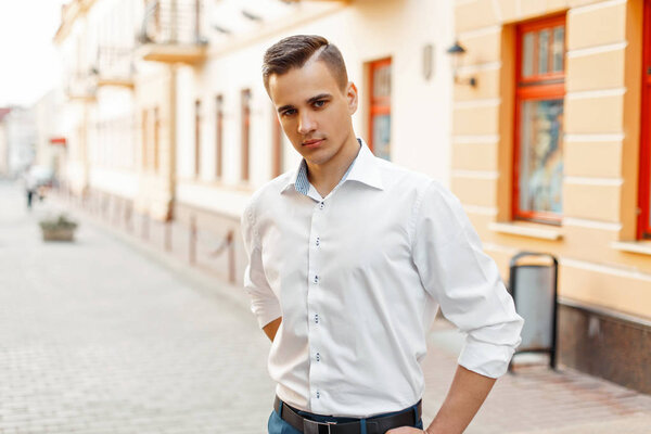 Elegant man in a white shirt in the city