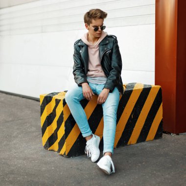 Şık modern marka kıyafetler moda yakışıklı genç adam siyah ve sarı omuz üzerine oturur