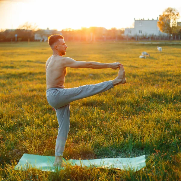 Mann beim Yoga bei Sonnenuntergang. Gesunder Lebensstil — Stockfoto