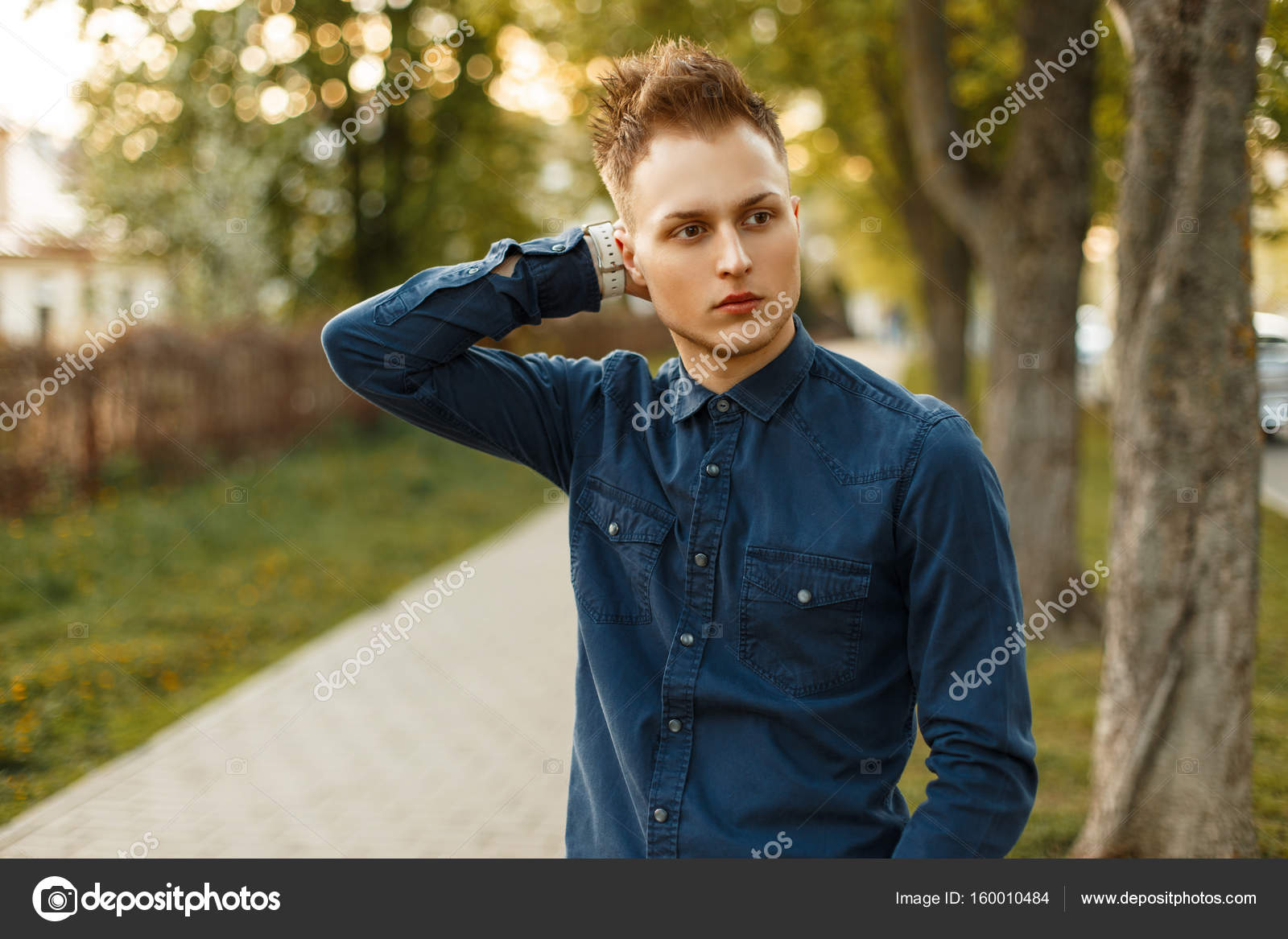 Handsome Young Stylish Man In A Blue Shirt Posing In The Park On A Sunny Day Stock Photo Image By C Alonesdj 160010484 https depositphotos com 160010484 stock photo handsome young stylish man in html
