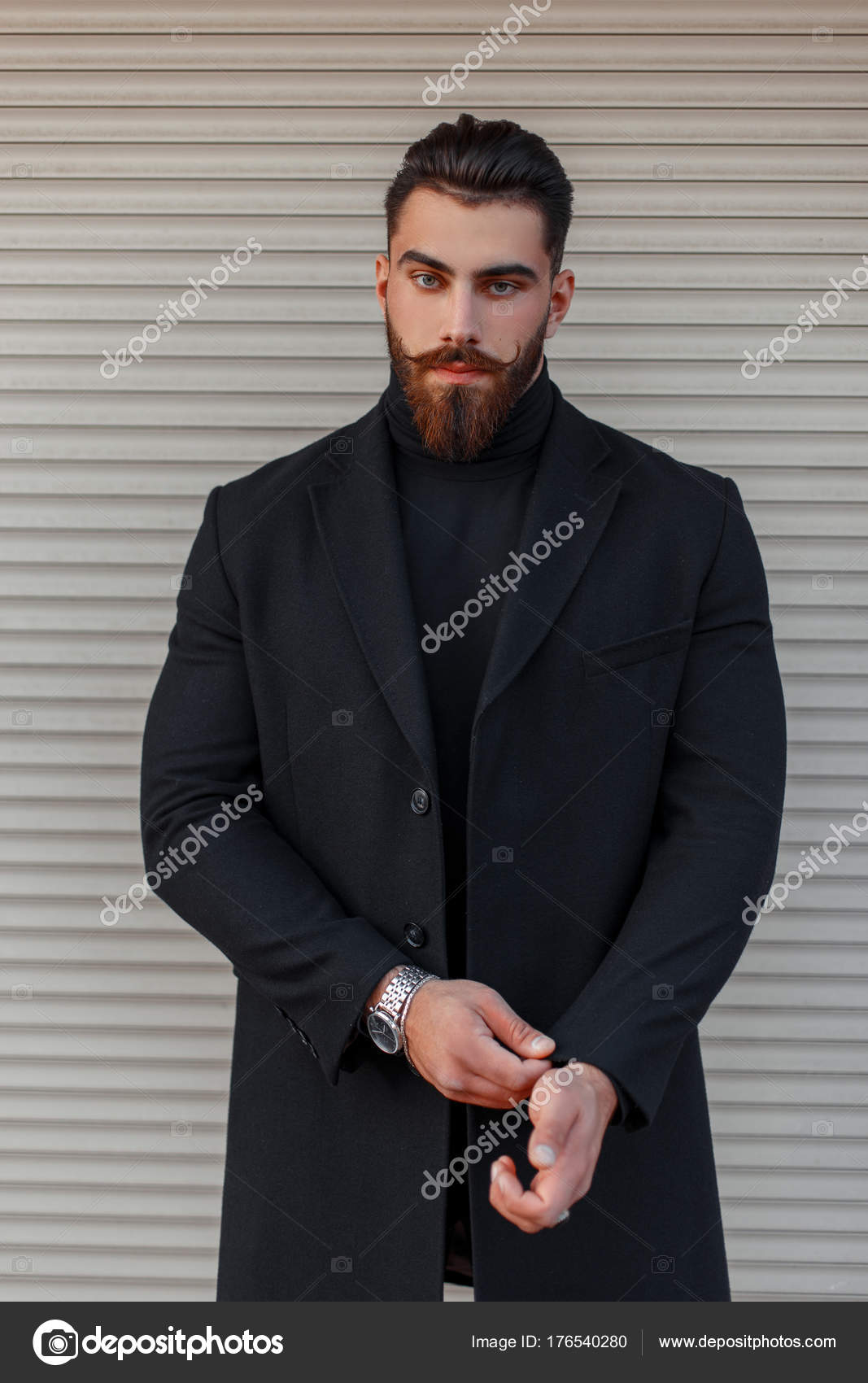 Detektiv Uregelmæssigheder lindre Stilfuld ung mand med frisure og skæg i en trendy sort frakke poserende nær  en metalvæg — Stock-foto © alonesdj #176540280