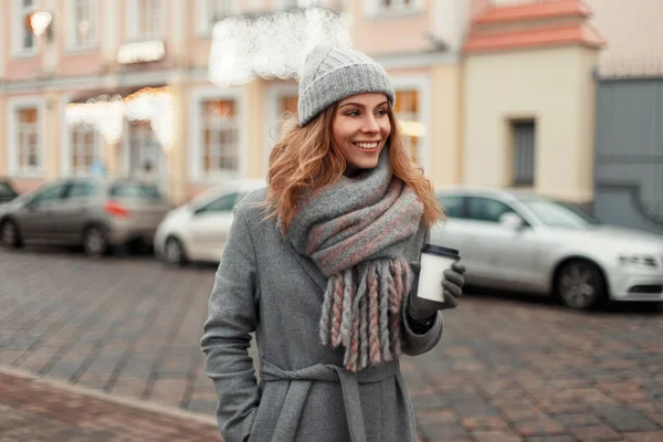 Happy young woman smiling in a trendy coat with a knitted vintag — Stock Photo, Image