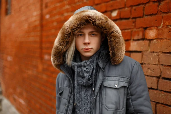 Stylish fashionable young man in a fashion winter jacket with a — Stock Photo, Image