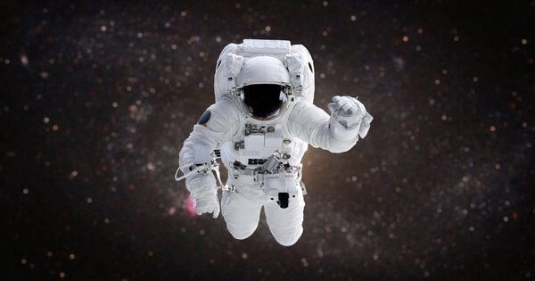 Spaceman. Astronaut in the open space against the background of the galaxy