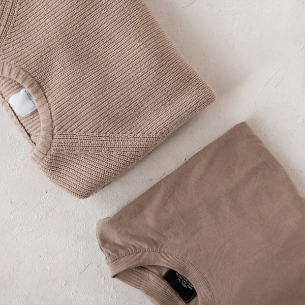Two male fashionable knitted beige sweaters on a white background. Stylish men's cotton sweater and vintage knitted cardigan. Trendy knitwear for men. Close-up. — 스톡 사진