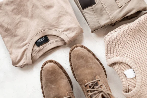 Cotton dress shirt with a knit woolen sweater with elegant boots with vintage trousers on the table. Stylish new spring collection of men's clothing and shoes. View from above. Close-up. — 스톡 사진
