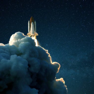 Space rocket launches into space against a starry blue sky. Ship shuttle with clouds of smoke