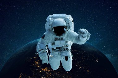 Astronaut in outer space on the background of the planet Earth. Spaceman levitates. Travel concept
