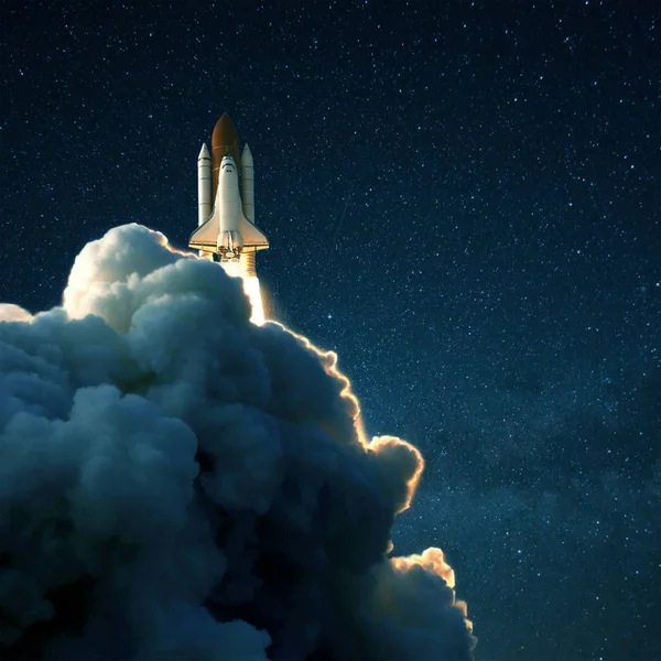 Space rocket launches into space against a starry blue sky. Ship shuttle with clouds of smoke — 스톡 사진
