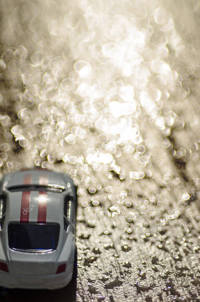 car toy for kid in bokeh of water and shine