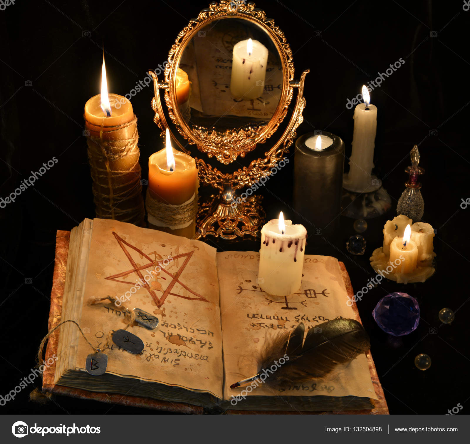 Old book, skull, candles and mirror. Halloween concept ??? Stock Photo