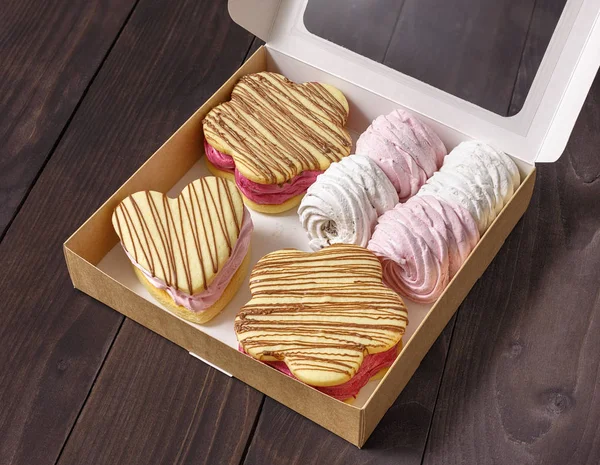Cake, dessert, assorted in a box on a wooden background