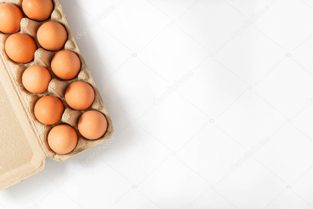 Eggs in a paper tray placed on a white background,top view