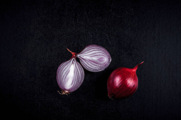 Different types of onions on a black background