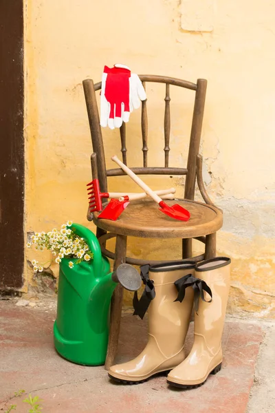 garden still life with gum boots and garden tools