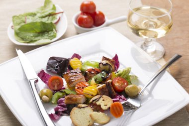 Tabakta çeşitli sebzelerle ızgara tavuk göğsü salatası