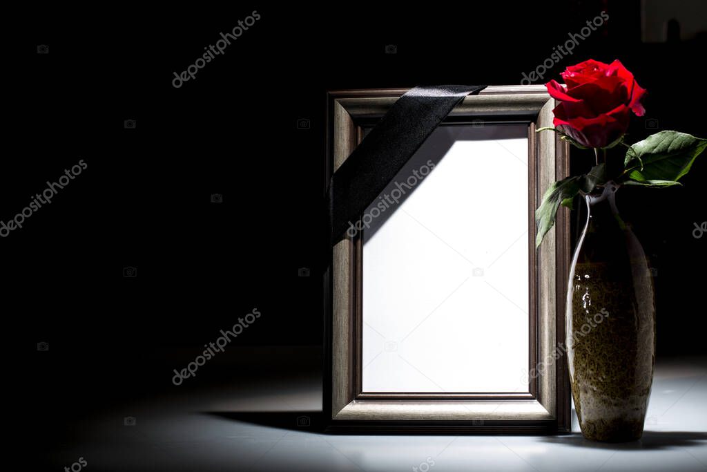 Blank mourning frame for sympathy card on dark background