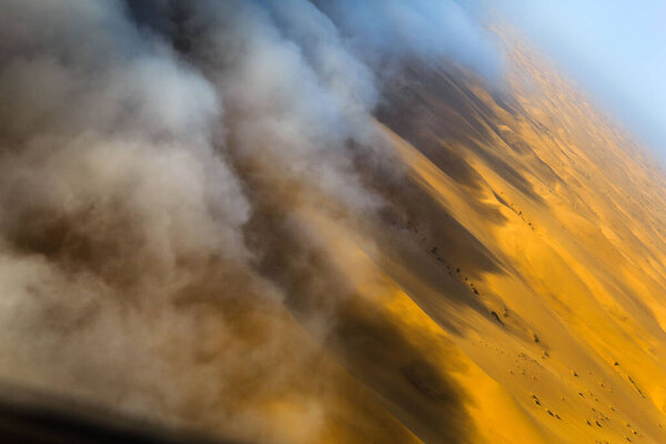 Sand dunes of Namib desert from aircraft on Skeleton coast in Namibia.