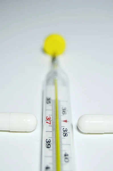 temperature with medicines on a white background vertical orientation