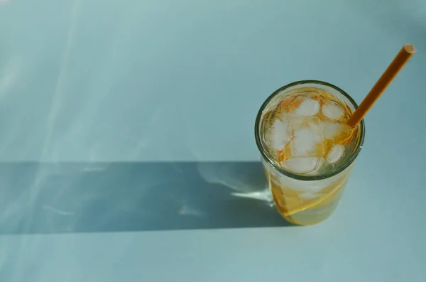 Лимонная Вода Льдом Стеклянном Стакане Желтой Трубкой Фоне Мяты Тенью — стоковое фото