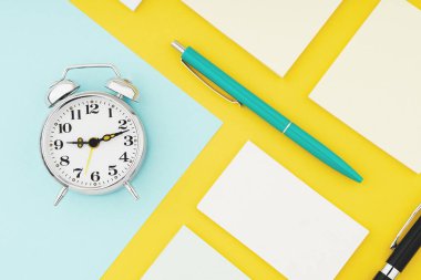 Alarm clock and colour paper concept