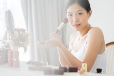 Makyaj fırçasından genç Asyalı kadın makyajı