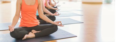 Yoga sınıflarında yoga pozisyonu alan ve egzersiz yapan çekici Asyalı genç kadın grubu.