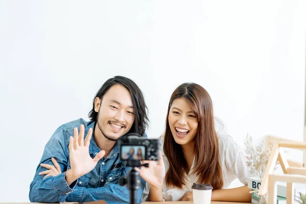 Young Asian couple blogger with recording video