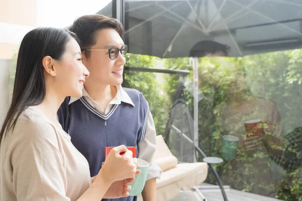 Genç Asyalı Çift Modern Evde Kahve Içerek Rahatlıyor Dışarıya Bakıyor — Stok fotoğraf