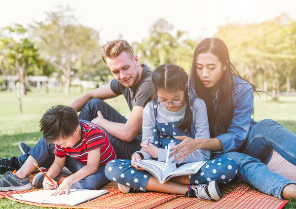 father, mother and son and daughter. parents and children doing homework