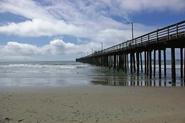 Perspectief Panoramisch Uitzicht Een Oceaanstrand Een Pier Onder Een Levendige — Stockfoto