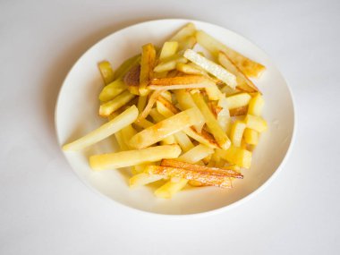 Kızarmış patatesleri beyaz tabakta yemek. Yan görünüm