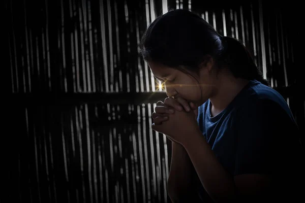 Girl while praying for christian religion with blurred of her bo — Stock Photo, Image