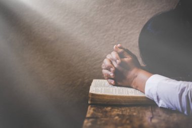 Kilise kavramında kutsal bir İncil 'e dua etmek için eller kavuşturuldu.