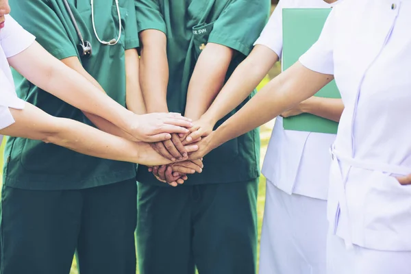 Surgeon medical people handshaking.Doctors and nurses in a medical team stacking handsCross processing and Split tone instragram like process.