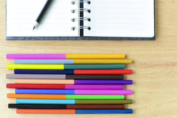 Back to school. Colorful Office and study art stationery objects on wood table with open notebook.Kid love to drowing.