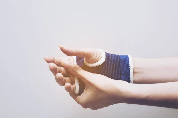 Blurry of arm splint, be in plaster cast.Injured female hand with upper part of body. Hand is bandaged with plaster.Split tone instagram like Processed.