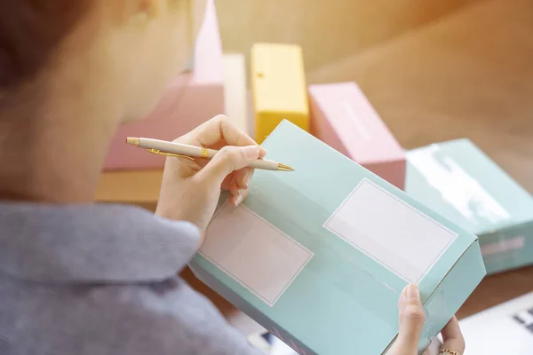 Delivery Mail Shipping Woman Seller Prepares the Delivery Box. Packing Accessories at Workplace.Cardboard Parcel Box for Online Selling. Ecommerce Startup Small Business Owner Shipping Products Concept, closeup