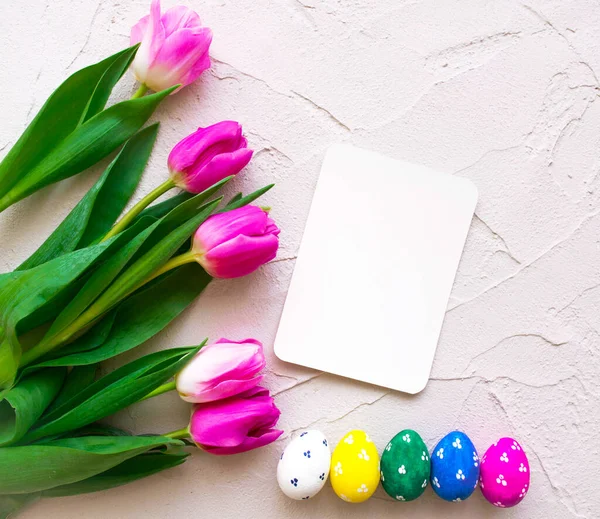 Happy ester, color eggs with tulips on background, place for text, top view