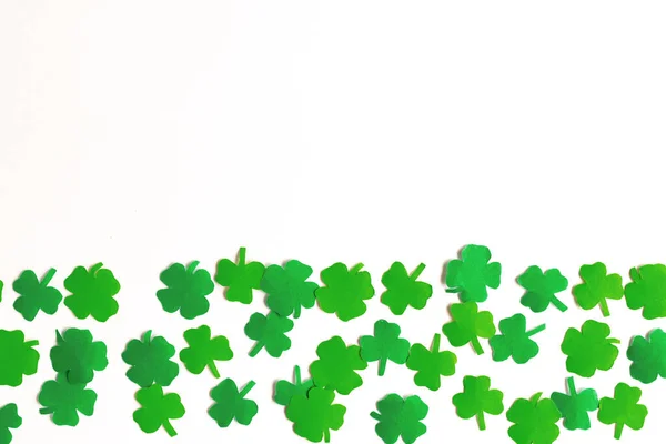 St.Patrick 's Day. Clover leaf background for design on white. Pattern of clover leaf cut out of paper.