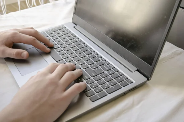 young man student working with laptop computer at home , lifestyle concept, stay at home during the Covid-19 coronavirus pandemic