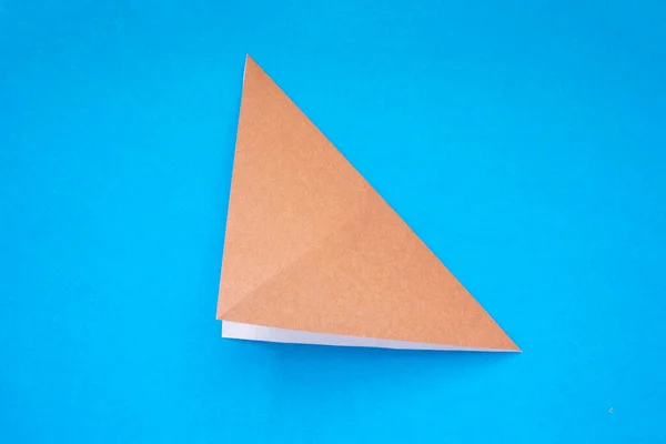 Step by step photo instruction how to make origami paper dog. Simple diy kids children's concept. Step 4.