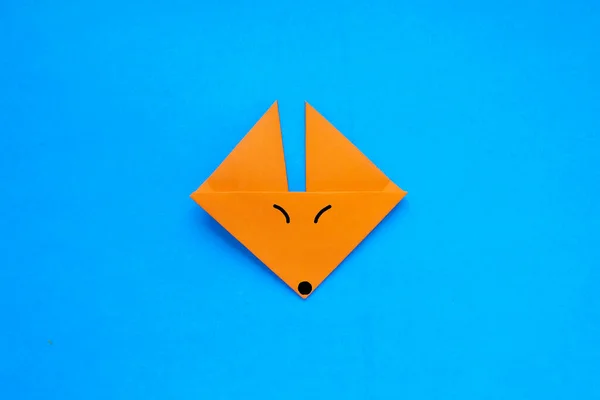 Step by step photo instruction how to make origami paper fox. Simple diy with kids childrens concept.
