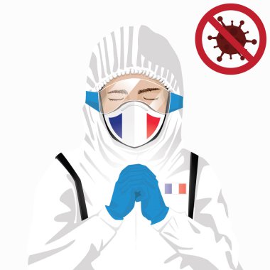 Covid-19 veya Coronavirus konsepti. Fransız sağlık personeli koruyucu giysiler içinde maske takıyor ve Fransa 'da Covid-19 virüs salgınına karşı dua ediyor. Fransız ve Fransız bayrağı. Salgın Korona Virüsü