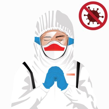 Covid-19 veya Coronavirus konsepti. Endonezyalı tıbbi personel koruyucu giysiler içinde maske takıyor ve Endonezya 'daki Covid-19 virüs salgınına karşı dua ediyor. Endonezya adamı ve Endonezya bayrağı. Pandemik korona virüsü
