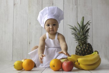 Little chef with fruits. 