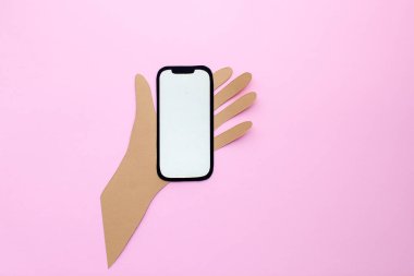 Paper phone on hand.