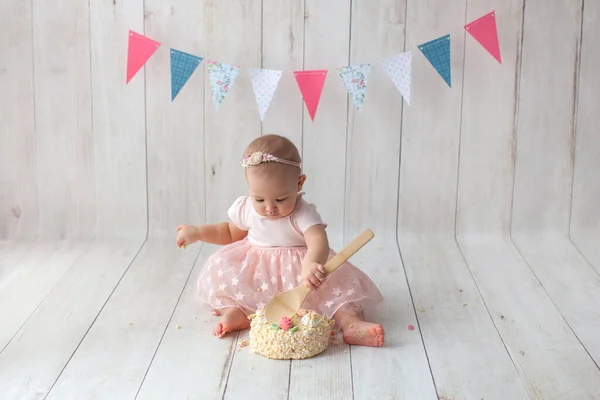 First baby birthday. Flag garland on background. Smash cake.