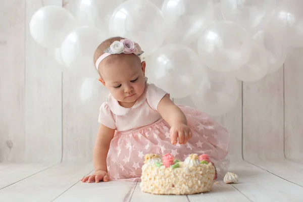First baby birthday. Handmade balloon garland on background. Smash cake.