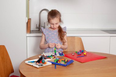 7 yaşındaki kız plastikçiden heykel yapıyor. Yakın plan.. 